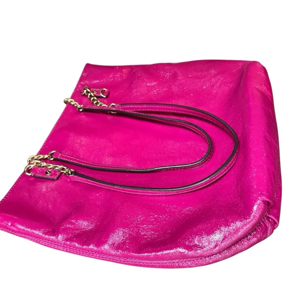 Michael Kors patent leather handbag in a sleek, glossy finish.